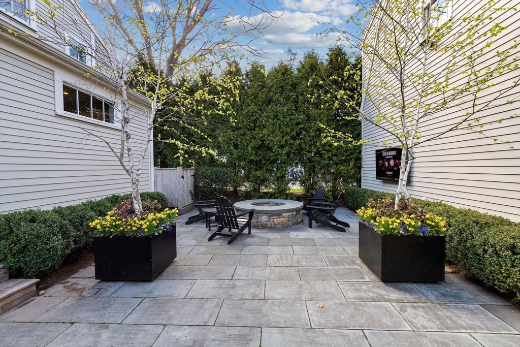 132 Main Street Hingham, MA 02043 - Photo 34 of 42 a bunch of flowers sitting in front of a house