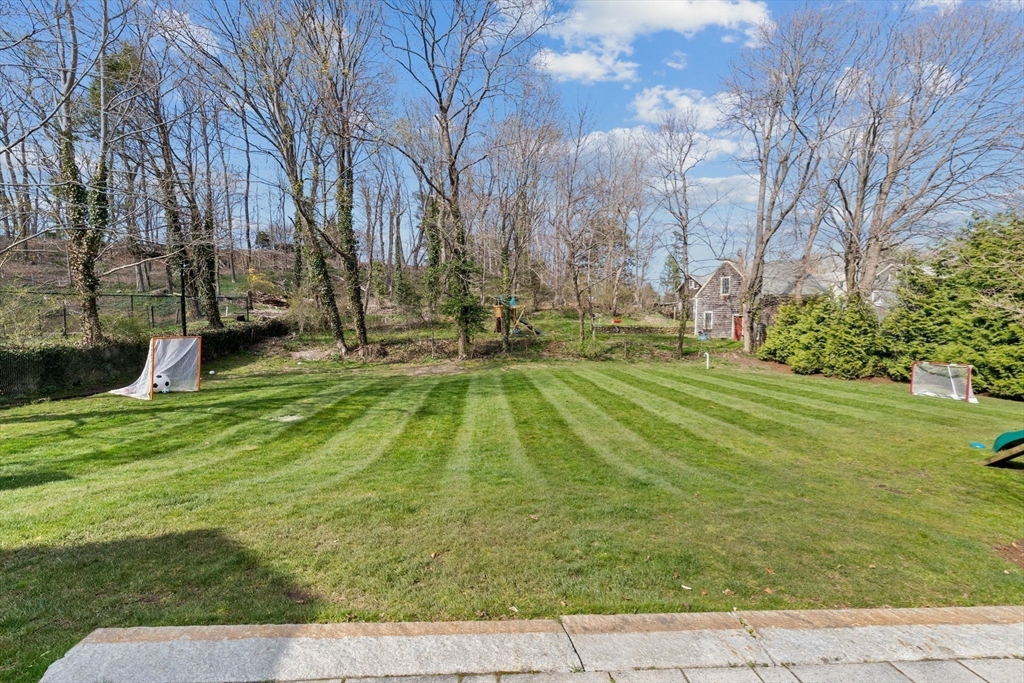 132 Main Street Hingham, MA 02043 - Photo 35 of 42 a backyard of a house with lots of green space