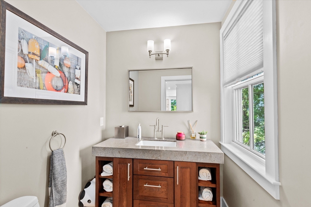 132 Main Street Hingham, MA 02043 - Photo 8 of 42 a bathroom with a granite countertop sink and a mirror