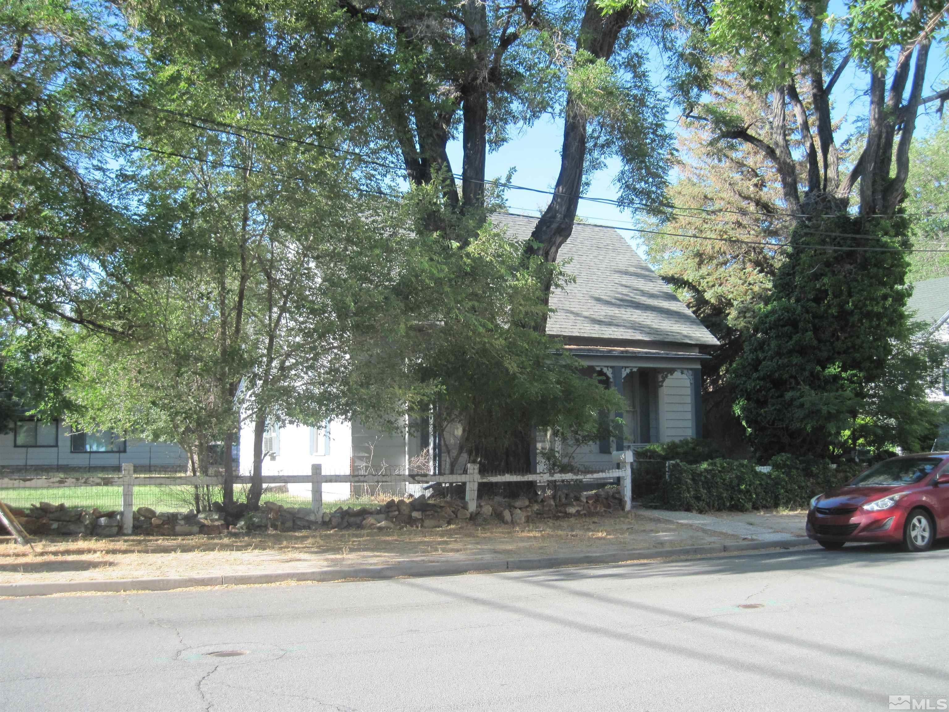 a view of a house with a patio and a yard