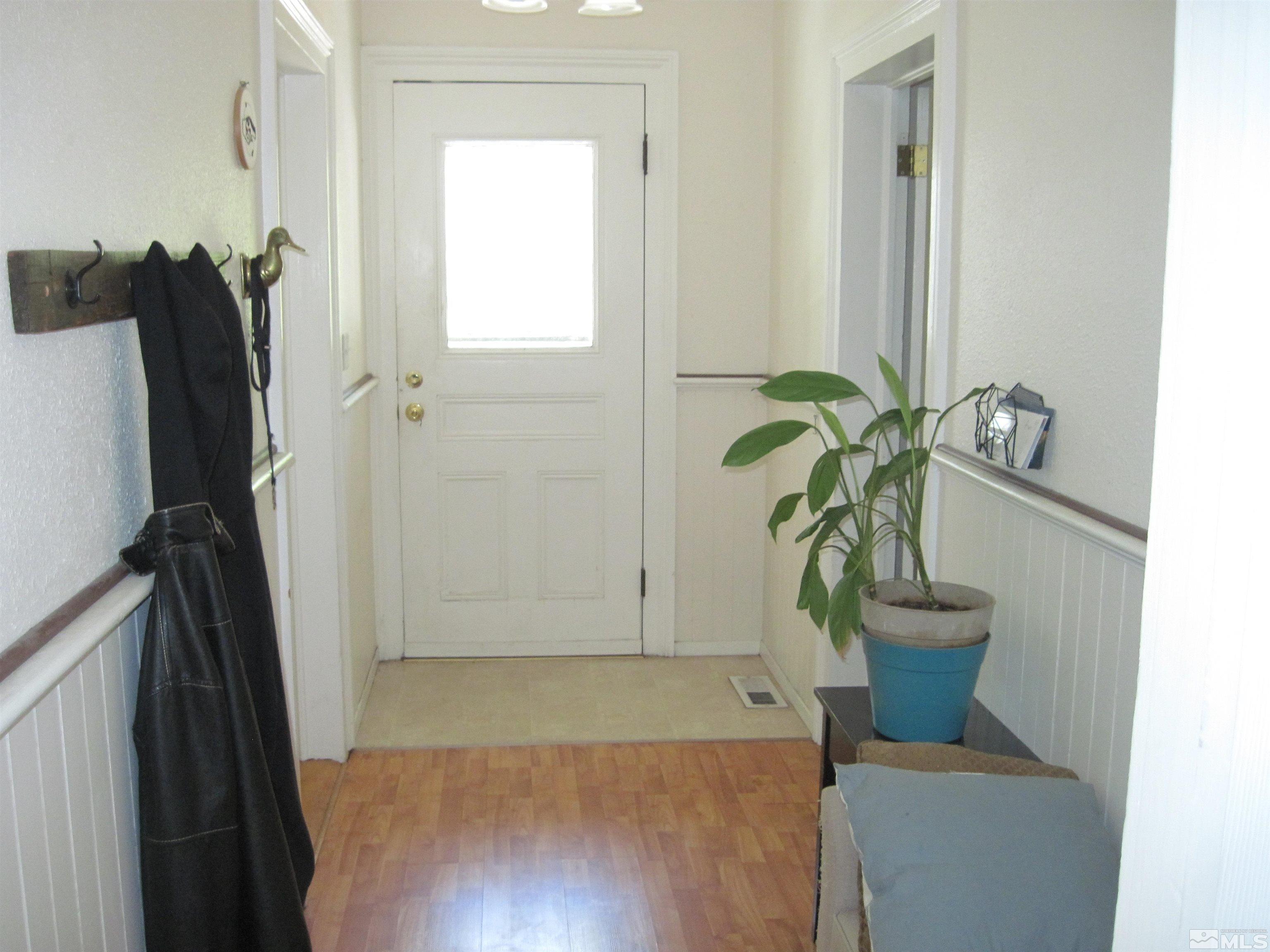 Undisclosed Address Carson City, NV 89703 - Photo 5 of 13 a view of a hallway with wooden floor and a potted plant