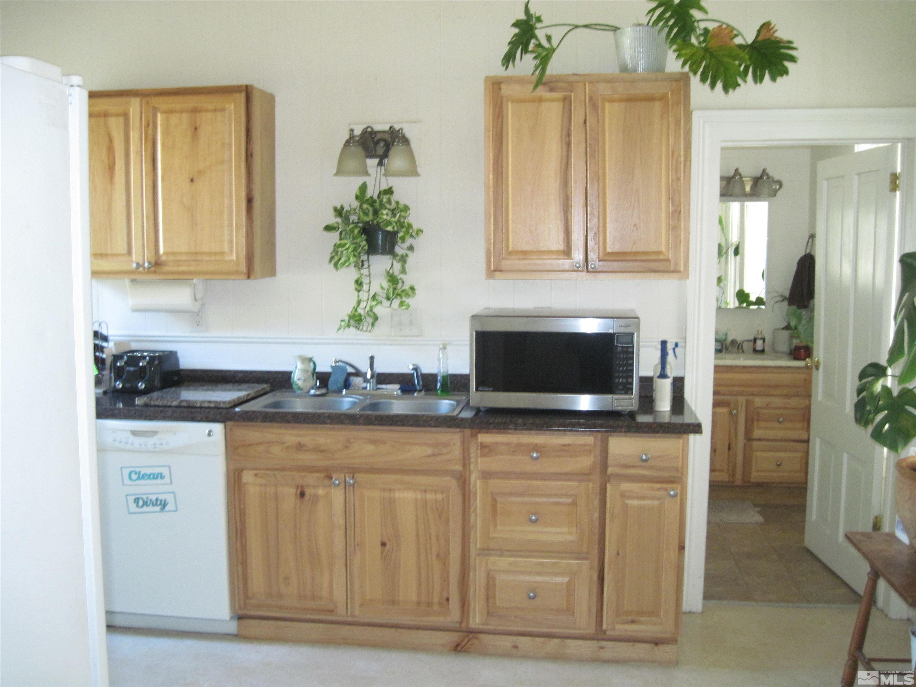 Undisclosed Address Carson City, NV 89703 - Photo 7 of 13 a kitchen with granite countertop a sink and a stove