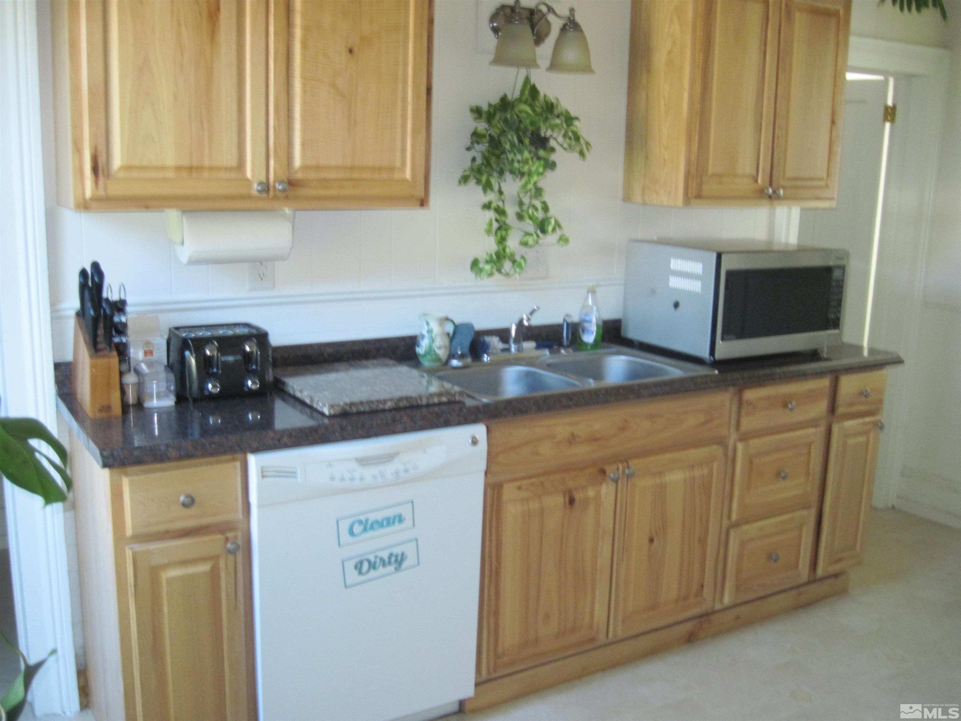 Undisclosed Address Carson City, NV 89703 - Photo 9 of 13 a kitchen with granite countertop white cabinets and a sink