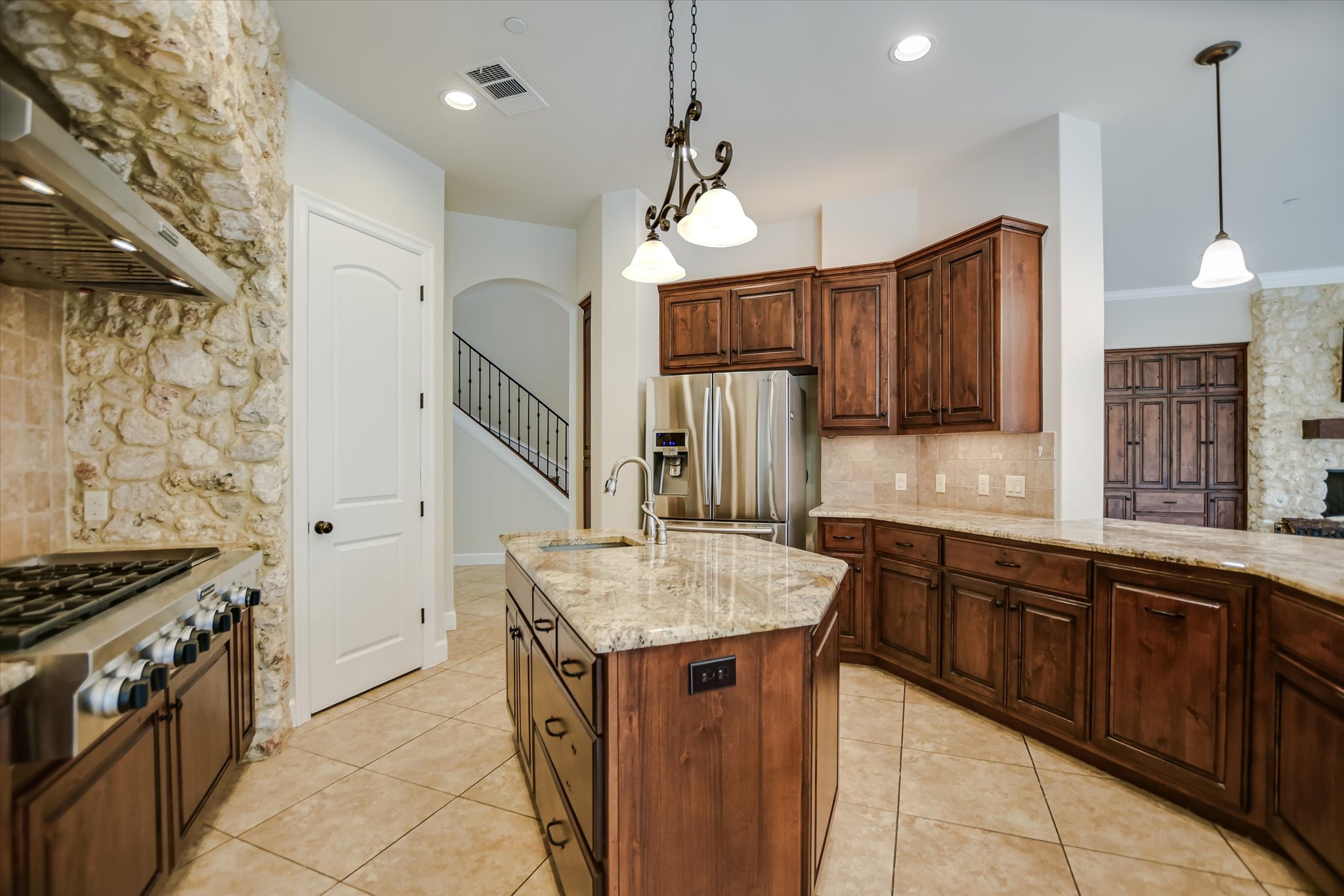 11 Inwood Circle Austin, TX 78746 - Photo 15 of 38 Culinary aspirations come to life in this kitchen, featuring an oversized island, gas range, and stone accents.