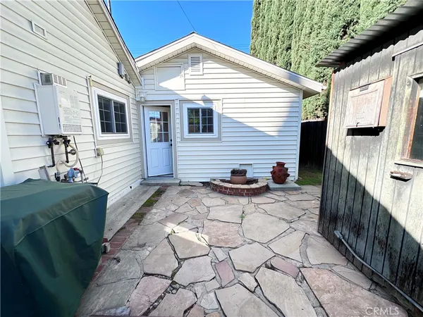 a view of house with backyard and sitting area