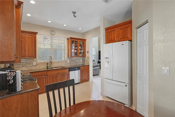 a kitchen with stainless steel appliances granite countertop a refrigerator and a sink