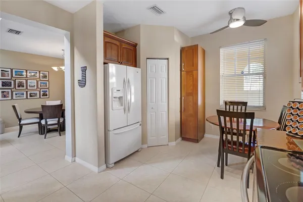 a view of kitchen with furniture and refrigerator