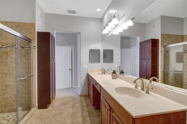 a bathroom with a sink vanity and a mirror