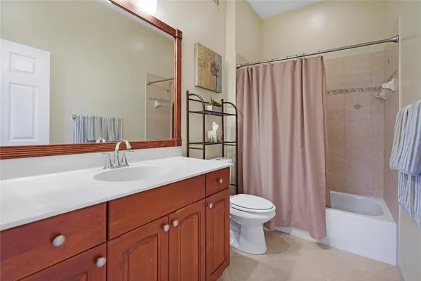 a bathroom with a sink toilet double vanity and shower