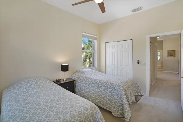 a bedroom with two beds and a window