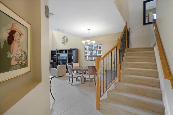 a view of staircase with furniture and lots of frames on wall