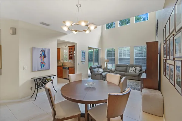 a view of a dining room with furniture a chandelier and wooden floor