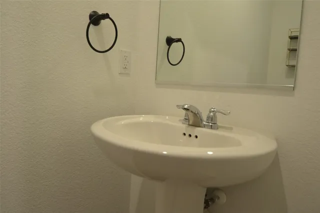 a kitchen with a sink dishwasher and a stove with wooden floor