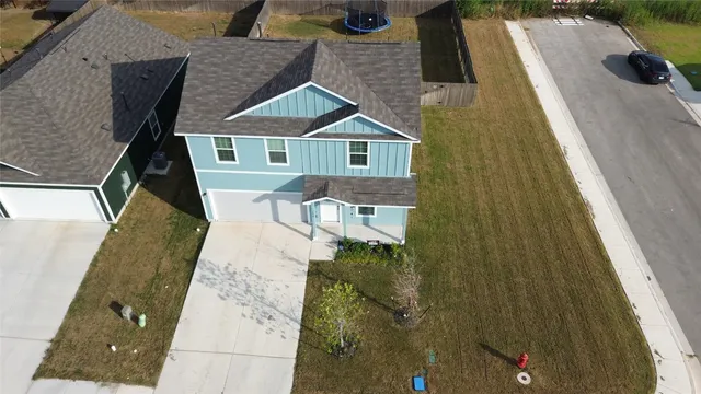 a aerial view of a house with a yard