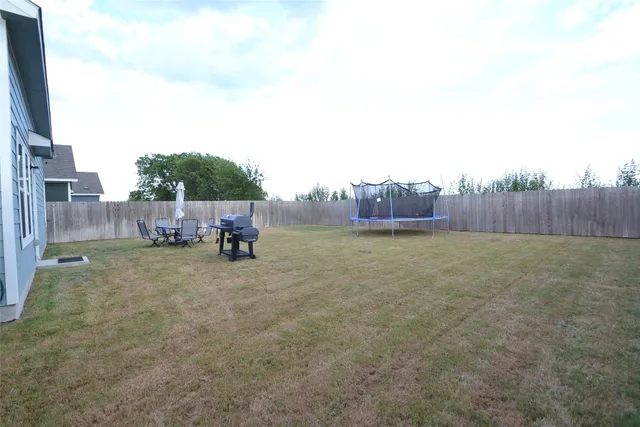 a view of a patio with a table and chairs