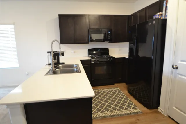 a kitchen with a sink and a refrigerator