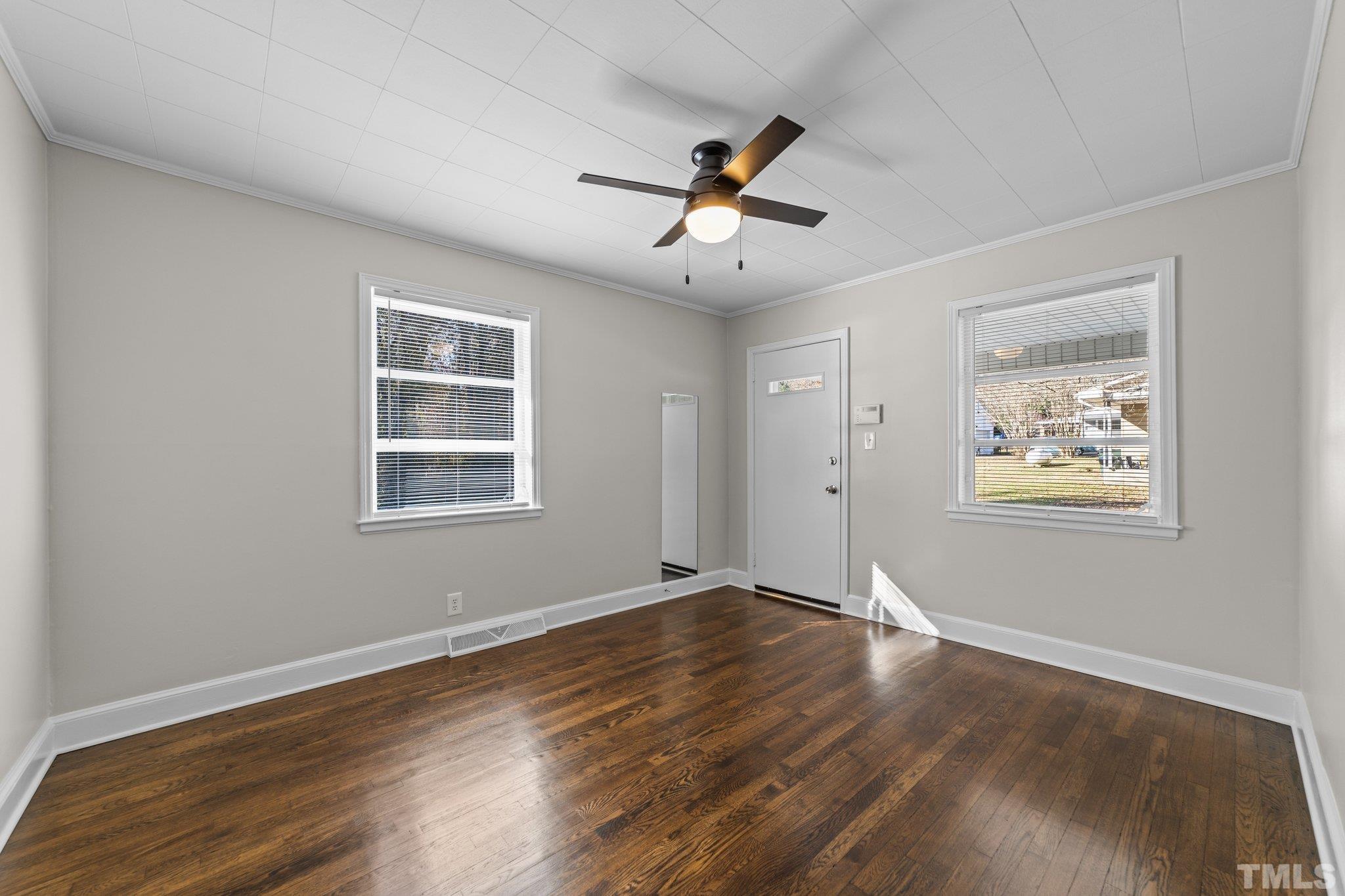908 Goodwin Road Durham, NC 27712 - Photo 12 of 22 a view of an empty room with wooden floor and a window