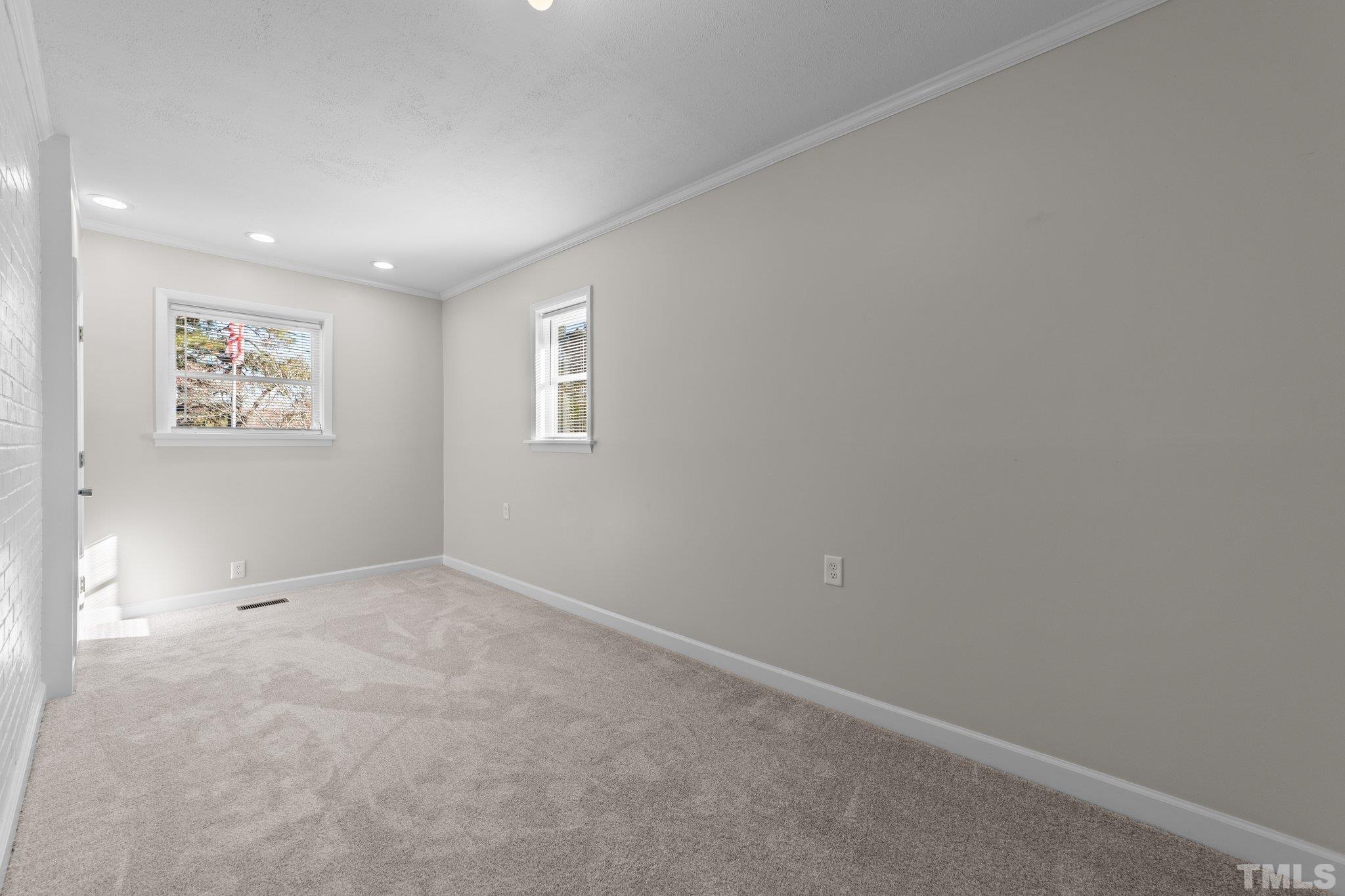 908 Goodwin Road Durham, NC 27712 - Photo 17 of 22 an empty room with windows