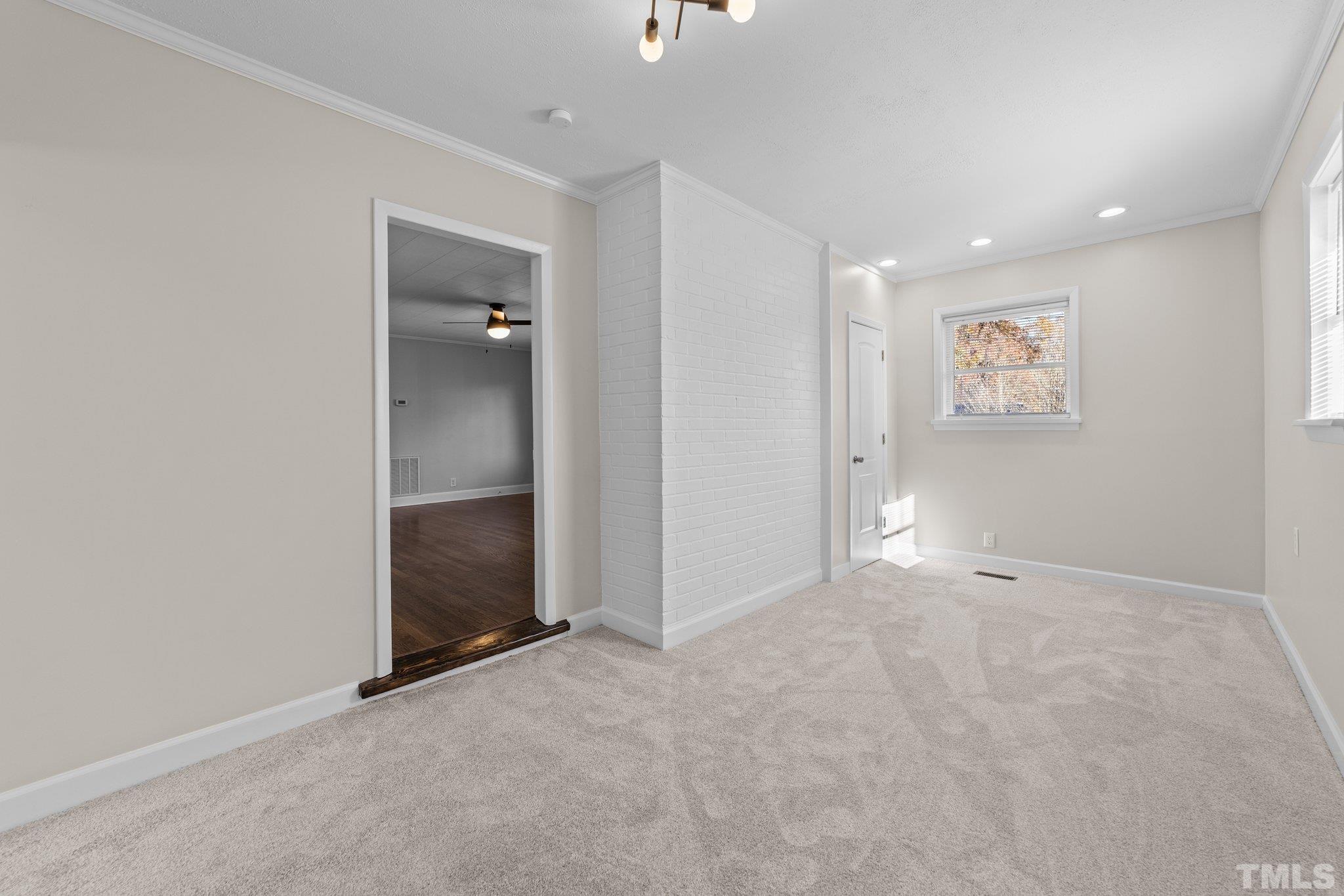 908 Goodwin Road Durham, NC 27712 - Photo 18 of 22 an empty room with closet and mirror