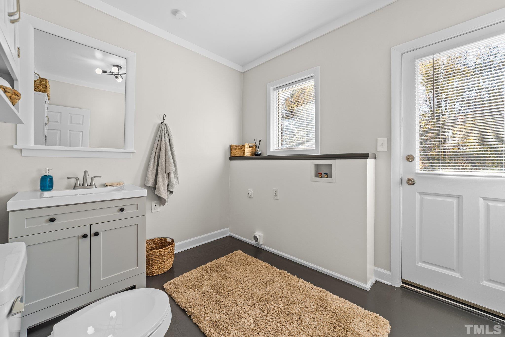 908 Goodwin Road Durham, NC 27712 - Photo 19 of 22 a bathroom with a sink a toilet and window