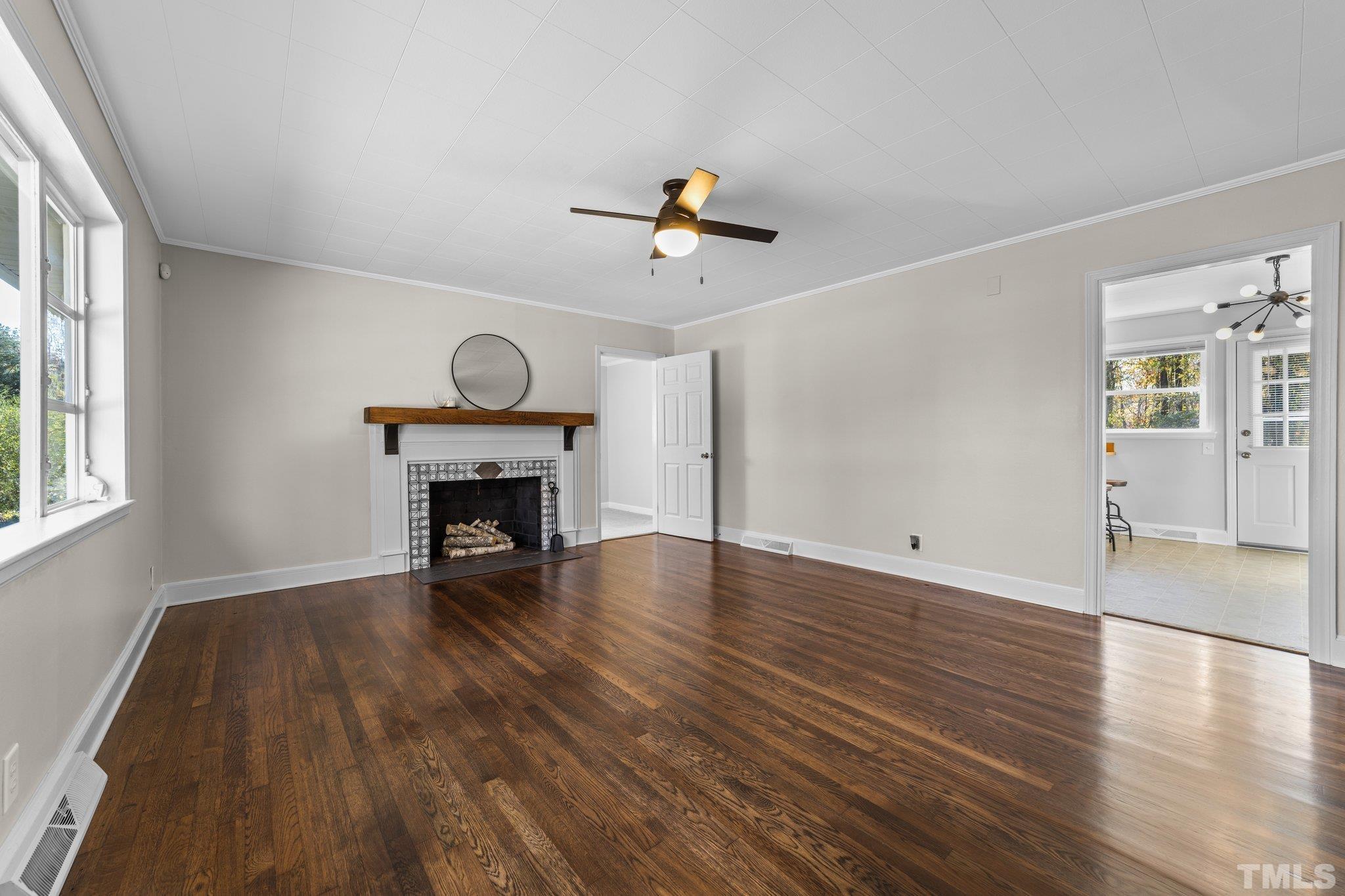 908 Goodwin Road Durham, NC 27712 - Photo 4 of 22 wooden floor in an empty room with a window