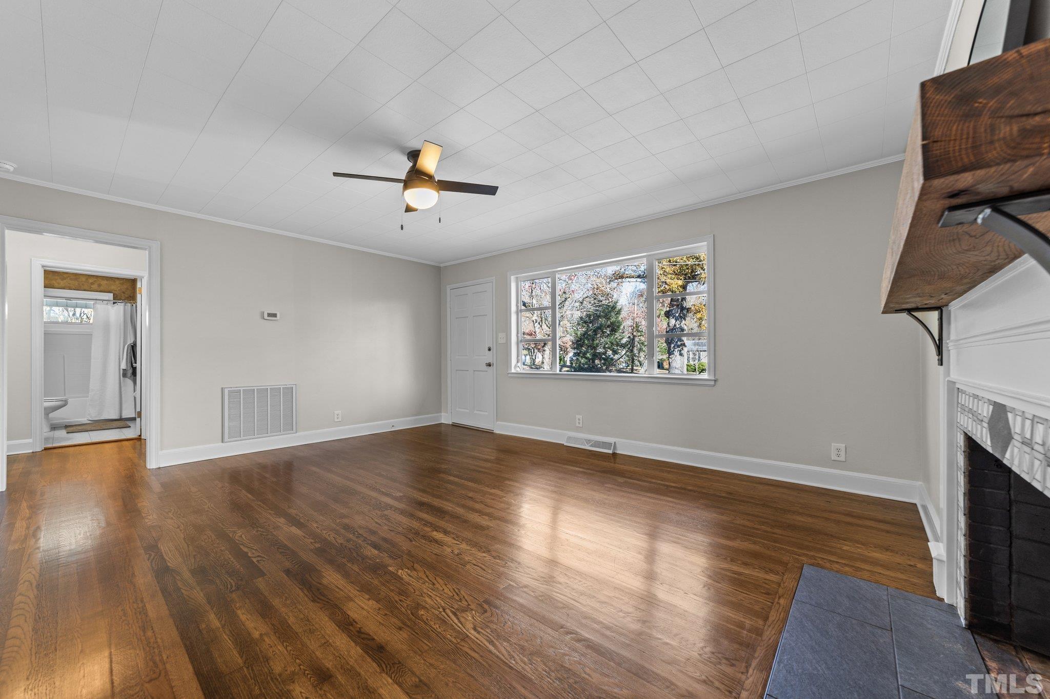 908 Goodwin Road Durham, NC 27712 - Photo 5 of 22 wooden floor in an empty room with a window