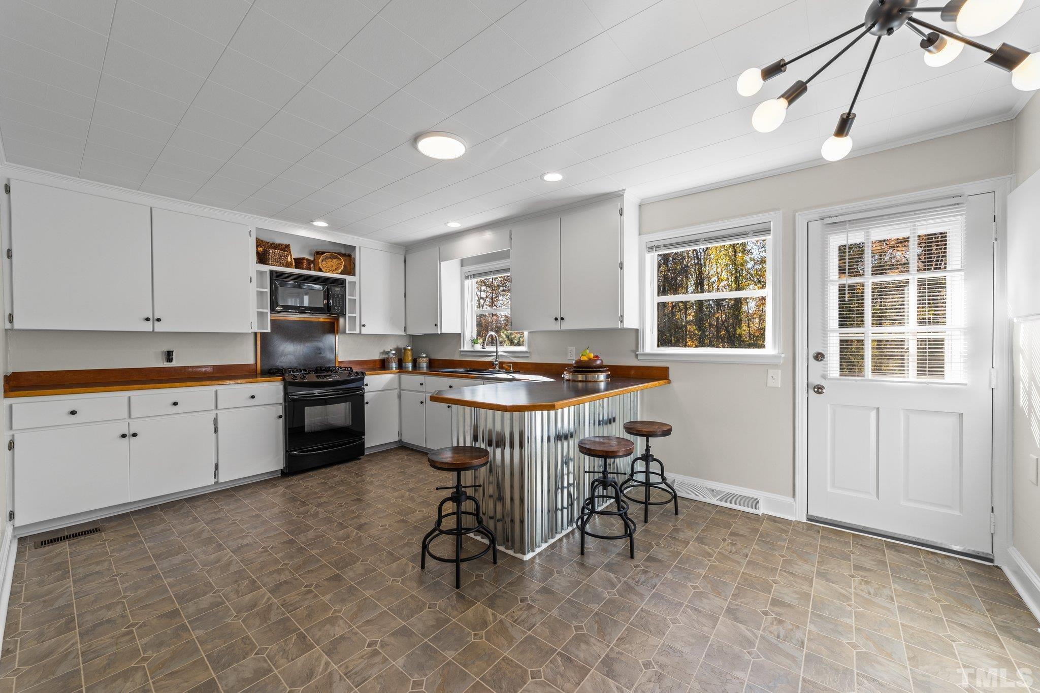 908 Goodwin Road Durham, NC 27712 - Photo 6 of 22 a kitchen with a sink cabinets and window
