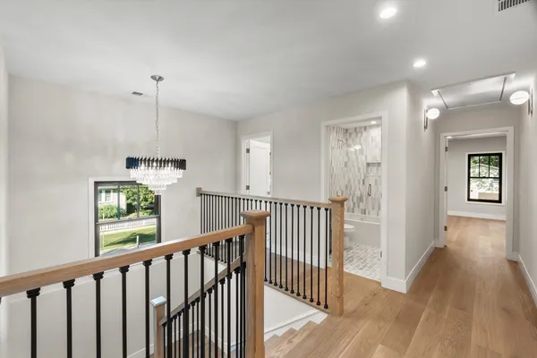 a view of hallway with wooden floor