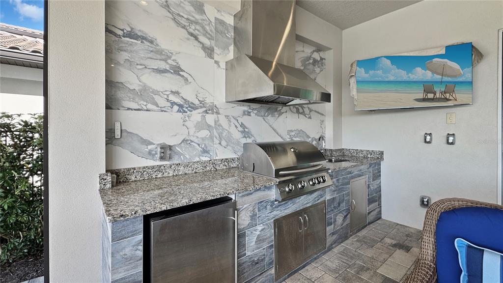 7948 Jacks Clb Drive Reunion, FL 34747 - Photo 12 of 85 a kitchen with stainless steel appliances granite countertop a stove and a sink