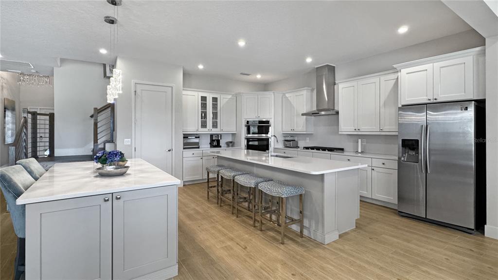 7948 Jacks Clb Drive Reunion, FL 34747 - Photo 16 of 85 a kitchen with kitchen island stainless steel appliances a sink a stove a refrigerator and a center island