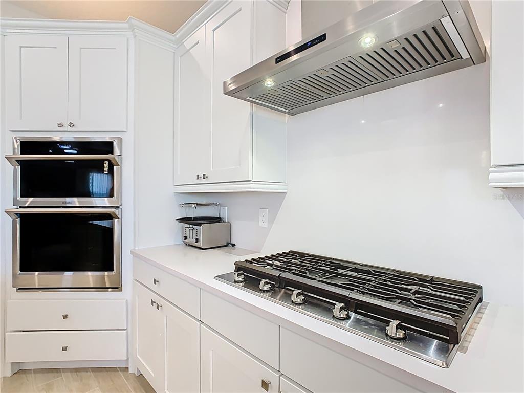 7948 Jacks Clb Drive Reunion, FL 34747 - Photo 18 of 85 a kitchen with a stove and white cabinets