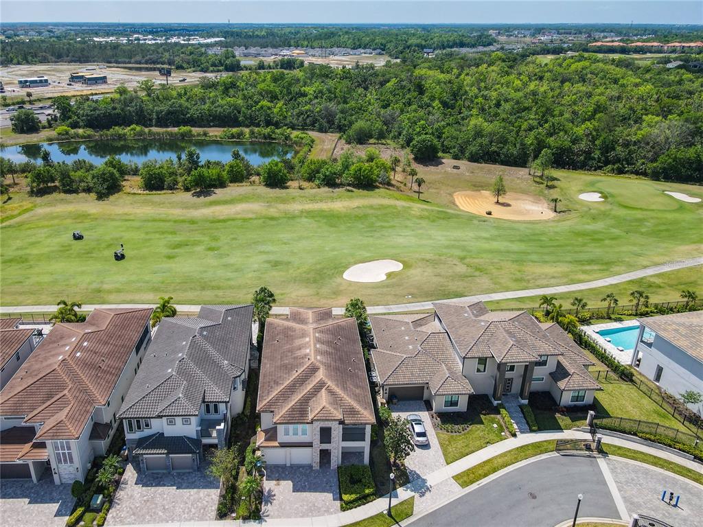 7948 Jacks Clb Drive Reunion, FL 34747 - Photo 2 of 85 an aerial view of a house with a garden and lake view