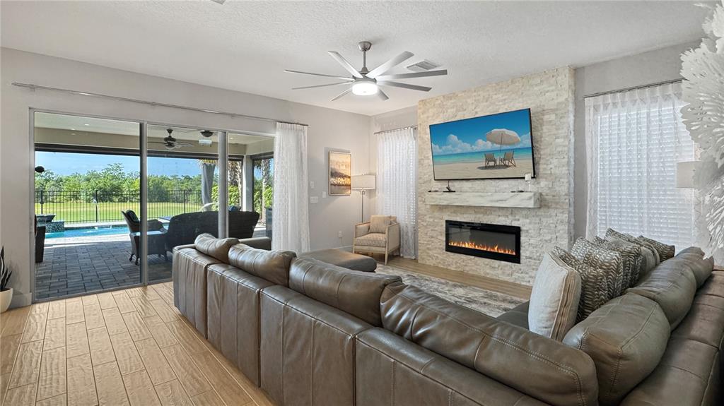 7948 Jacks Clb Drive Reunion, FL 34747 - Photo 22 of 85 a living room with furniture and a fireplace