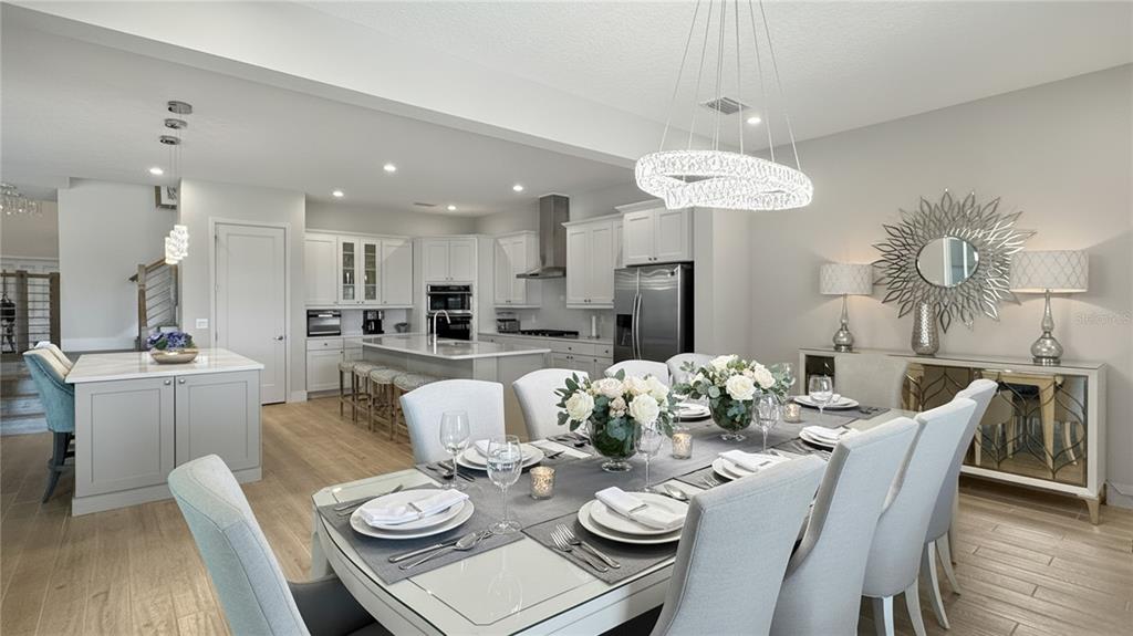7948 Jacks Clb Drive Reunion, FL 34747 - Photo 24 of 85 a view of a dining room with furniture a chandelier and wooden floor