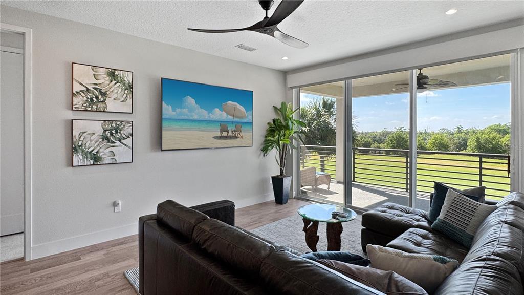 7948 Jacks Clb Drive Reunion, FL 34747 - Photo 30 of 85 a living room with furniture and a large window
