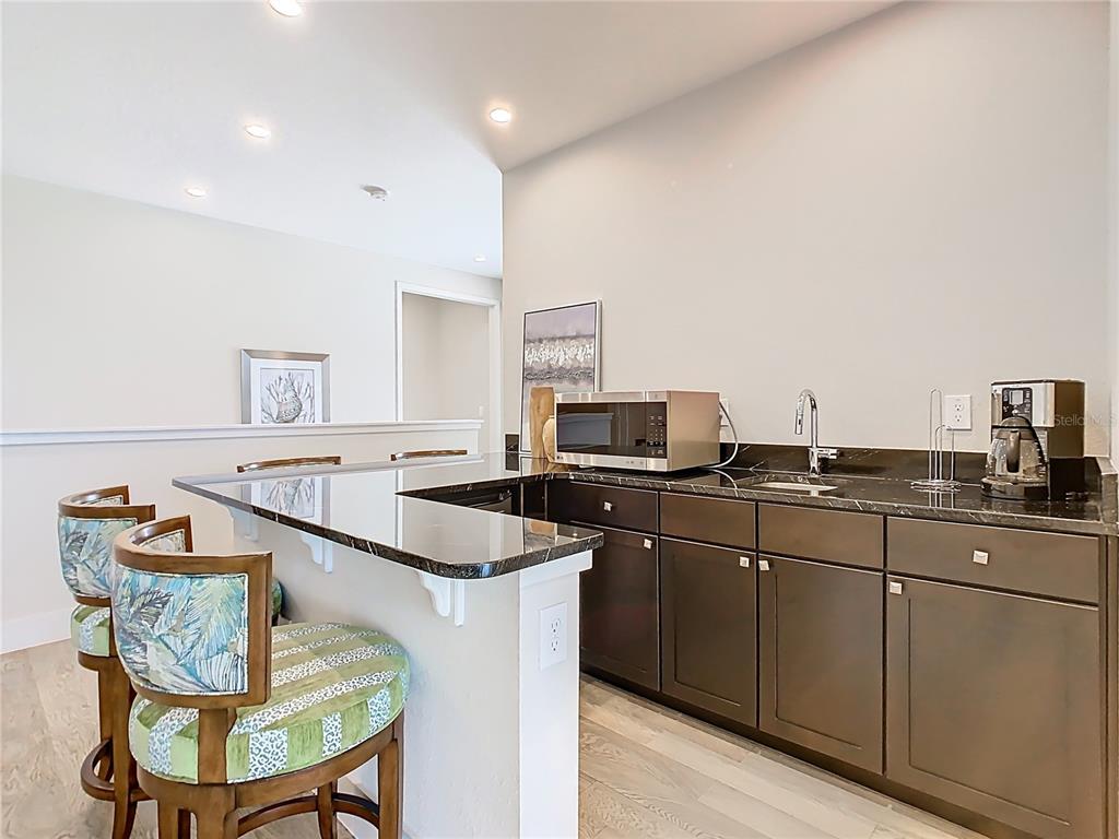7948 Jacks Clb Drive Reunion, FL 34747 - Photo 33 of 85 a kitchen with stainless steel appliances a sink and a refrigerator