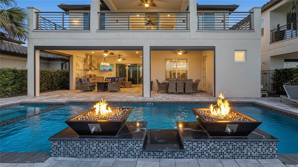 7948 Jacks Clb Drive Reunion, FL 34747 - Photo 4 of 85 a view of a patio with couches chairs potted plants and wooden floor