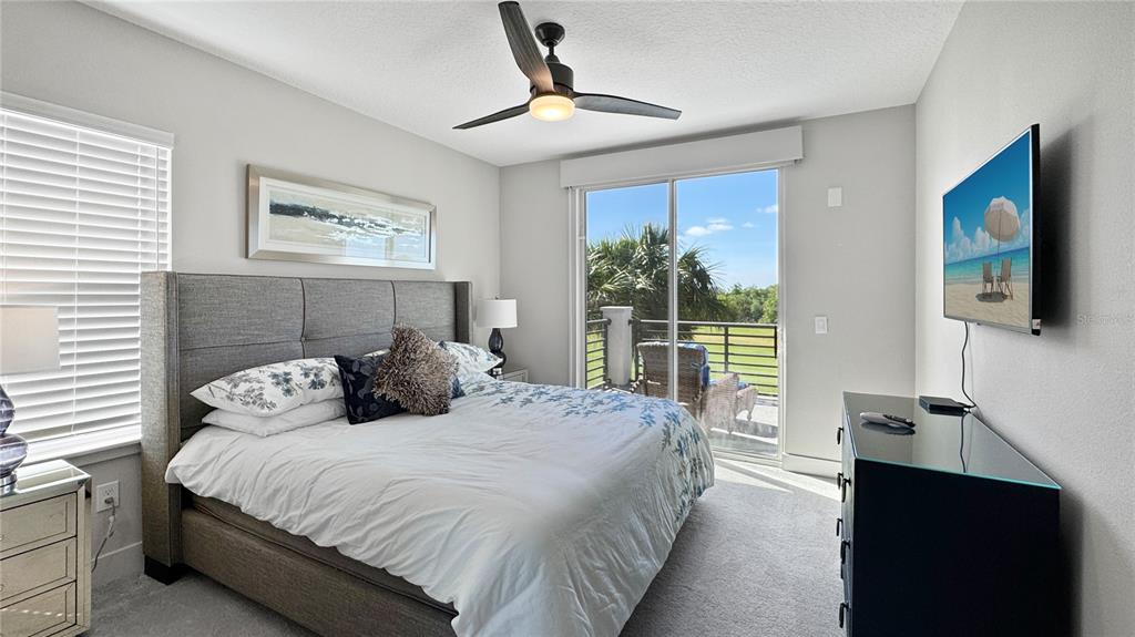 7948 Jacks Clb Drive Reunion, FL 34747 - Photo 45 of 85 a bedroom with a large bed and a window