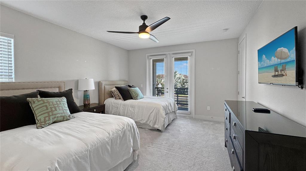 7948 Jacks Clb Drive Reunion, FL 34747 - Photo 47 of 85 a bedroom with two beds and a painting on the wall