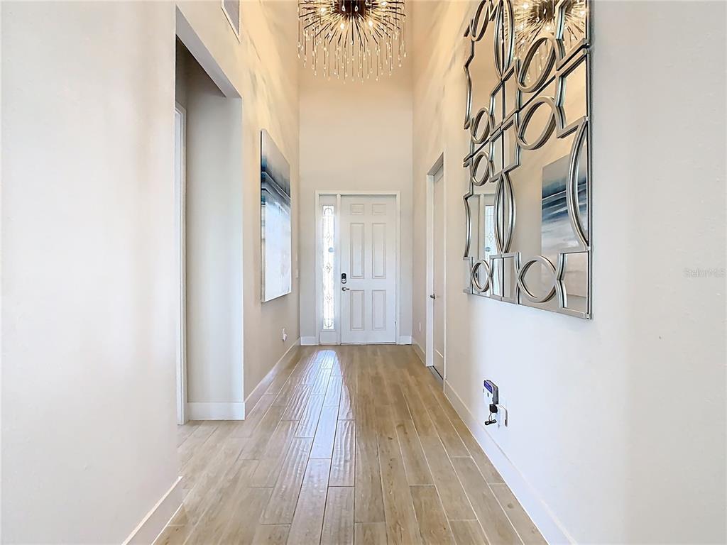 7948 Jacks Clb Drive Reunion, FL 34747 - Photo 52 of 85 a view of a hallway with wooden floor and a bathroom