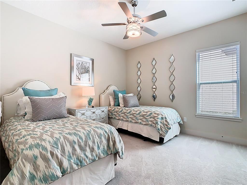 7948 Jacks Clb Drive Reunion, FL 34747 - Photo 54 of 85 a bedroom with two beds and a window