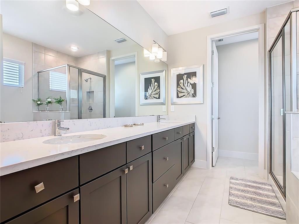 7948 Jacks Clb Drive Reunion, FL 34747 - Photo 56 of 85 a spacious bathroom with a double vanity sink mirror and double