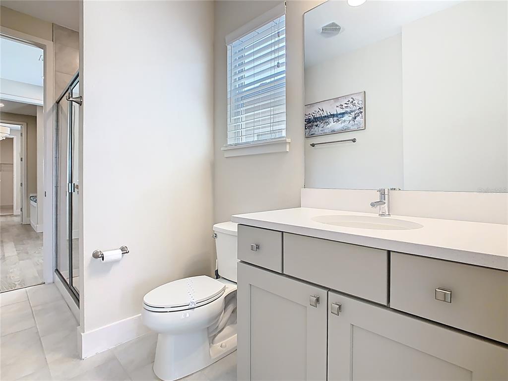 7948 Jacks Clb Drive Reunion, FL 34747 - Photo 62 of 85 a bathroom with a toilet sink and mirror