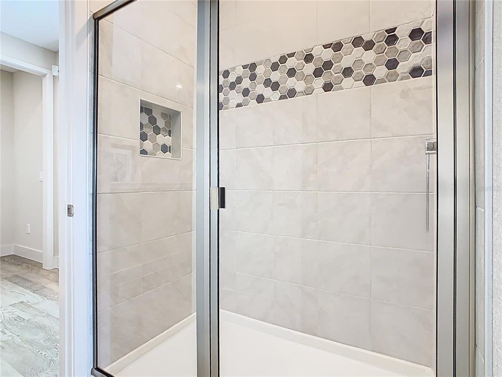 7948 Jacks Clb Drive Reunion, FL 34747 - Photo 63 of 85 a bathroom with a bathtub and a shower