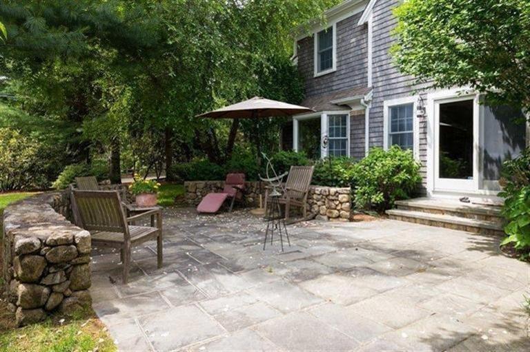 414 Eel River Road Osterville, MA 02655 - Photo 19 of 23 a view of a table and chairs under an umbrella