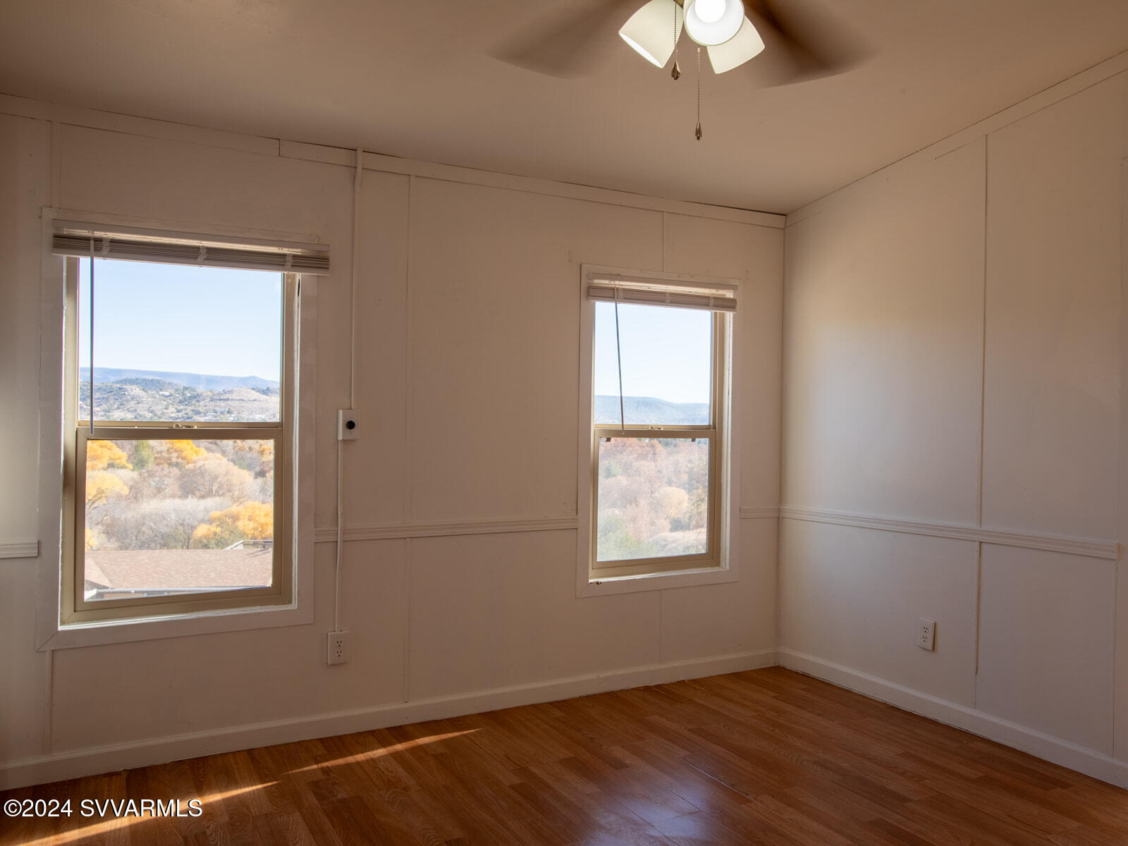 4950 Thunderhead Trail Rimrock, AZ 86335 - Photo 14 of 26 a view of an empty room with wooden floor and a window