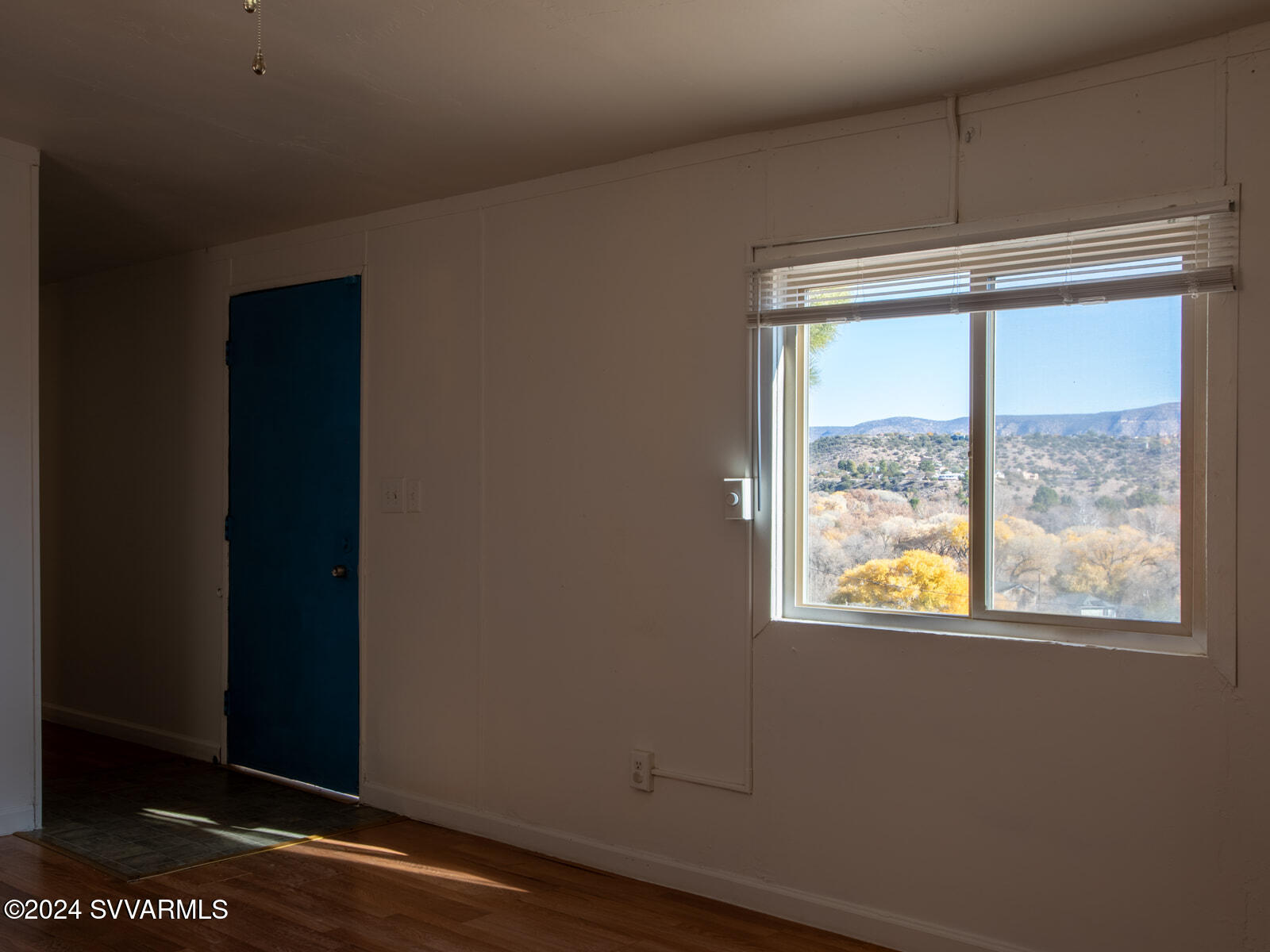 4950 Thunderhead Trail Rimrock, AZ 86335 - Photo 8 of 26 a view of an empty room with wooden floor and a window