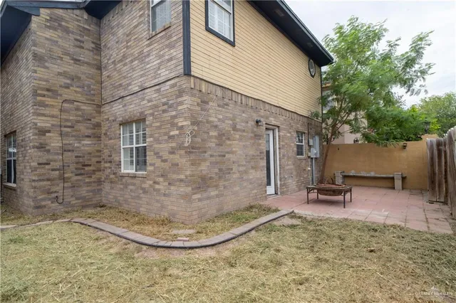 a backyard of a house with outdoor seating