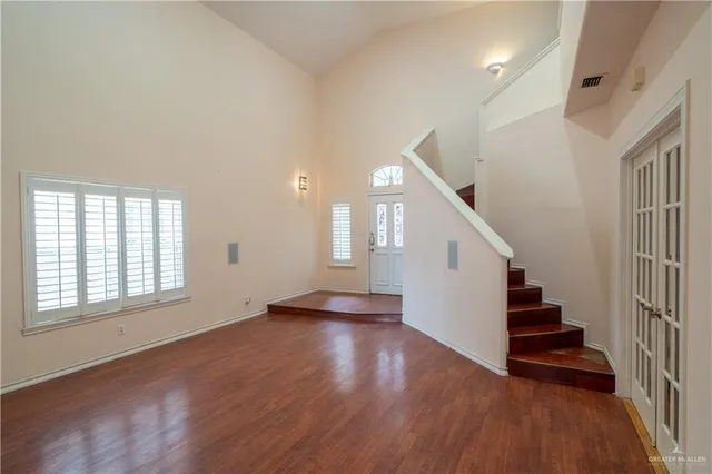 a view of an entryway with wooden floor and staircase