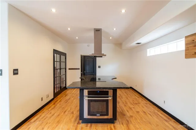 a kitchen with stainless steel appliances granite countertop a stove and a refrigerator